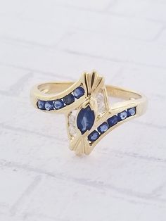 Vintage Sapphire & Diamond ring. Details: Size: US 6 1/2 ( can be sized ) Weight: 2.1 grams Primary stone: Genuine Sapphire Shape: Marquise & Round Secondary Stone: Diamond ( Appx. 0.06 tcw. ) Shape: Round Metal: 10k Yellow Gold Condition: Previously worn/great condition Inside of band is stamped and tested for '10k' gold. All pieces are polished and refinished in our shop. SIZING: Currently this ring is a size 6 1/2 but could be sized up or down for an additional small fee if desired by Vintage Sapphire, Sapphire And Diamond Ring, Initial Ring, Sapphire Diamond Ring, Multi Stone Ring, Sapphire Diamond, 10k Gold, Custom Rings, Stone Rings