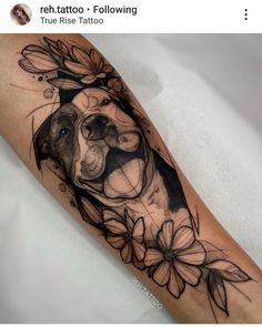 a black and white dog with flowers on it's leg is featured in this tattoo