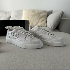 Brand-New Chanel White Calfskin Sneakers From 2023 Collection, Eu Size 36.5 (Fits Like A 36 As They Run Small). Your Purchase Includes The Original Box, Extra Laces, And Dust Bag. Any Questions? Reach Out Before Purchasing. Enjoy Poshing! Luxury Sneakers With Leather Sole And Flat Heel, Luxury Sneakers With Rubber Sole, Luxury Leather Sneakers With Flat Heel, Luxury Flat Heel Leather Sneakers, Luxury Calf Leather Slip-on Sneakers, Chic Sneakers With Leather Sole And Round Toe, Luxury Slip-on Sneakers With Perforated Toe Box, Luxury Calf Leather Sneakers With Perforations, Designer Calf Leather Slip-on Sneakers