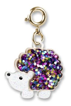 a keychain with a white bear on it's face and multicolored sequins