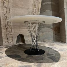 a white table sitting on top of a stone floor