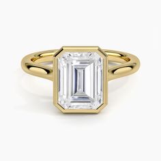 an emerald cut engagement ring in yellow gold