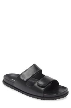 Adjustable straps lend another layer of comfort to a leather slide sandal set on a contoured footbed. Adjustable hook-and-loop straps Leather upper/synthetic lining/rubber sole Made in Brazil Black Slip-on Sandals With Adjustable Strap, Synthetic Slide Sandals With Adjustable Strap, Black Double Strap Sandals With Rubber Sole, Black Synthetic Footbed Sandals With Heel Loop, Synthetic Slides With Heel Loop, Synthetic Double Strap Slides With Adjustable Strap, Black Slides With Adjustable Strap, Black Double Strap Slides With Adjustable Strap, Black Double Strap Footbed Sandals With Adjustable Strap