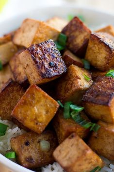 a white bowl filled with tofu and rice