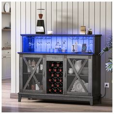 a blue lighted cabinet with wine glasses and bottles on it's sides, in front of a white wall