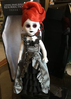 a doll with red hair wearing a dress