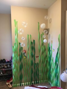 the room is decorated with balloons, streamers and seaweed for an ocean theme