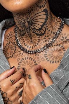 a woman with tattoos on her neck and chest