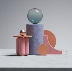 an abstract sculpture made out of concrete with a sphere sitting on top of the object