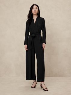 Formal Fall V-neck Jumpsuits And Rompers, Sleek V-neck Jumpsuits And Rompers For Work, Elegant V-neck Jumpsuit For Date Night, Formal V-neck Jumpsuits And Rompers For Fall, Sleek V-neck Jumpsuit For Workwear, Sleek Formal Jumpsuits And Rompers With V-neck, Sleek Formal V-neck Jumpsuits And Rompers, Elegant Fitted Jumpsuits And Rompers With Surplice Neckline, Elegant Spring Jumpsuits And Rompers With Surplice Neckline