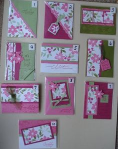 some cards and envelopes are arranged on a table with pink, green and white flowers