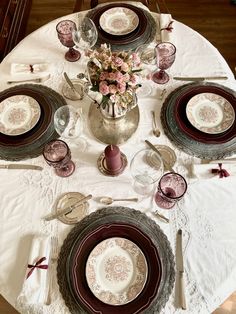 the table is set with plates and silverware