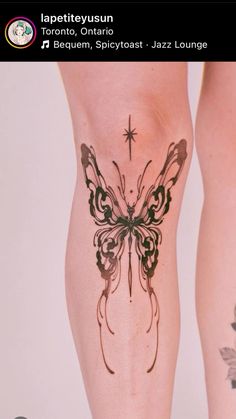 a woman's leg with a butterfly tattoo on it