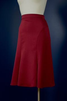 "The Florence-skirt is adapted from a 1930s sewing pattern. The skirt features curved seam lines that accentuate the hips, it fits snugly around the hips and flares out generously toward the knees. The flare at the bottom is close to a full circle! There is a zipper and a hook&bar closure on the side. This skirt is great for any modern vintage look, but it's especially made with dancers in mind, and looks great when you twirl. The skirt is made in a dark burgundy red suiting fabric. The fabric h Classic Fitted A-line Bottoms, Classic Fitted A-line Skirt, Fitted Flare Skirt In Solid Color, Solid Fitted Flare Skirt, Solid Flared Fitted Skirt, Solid Color Fitted Flare Skirt, Lined Flare Skirt, Fitted Flared Skirt With Pleats, Classic Fitted Burgundy Bottoms