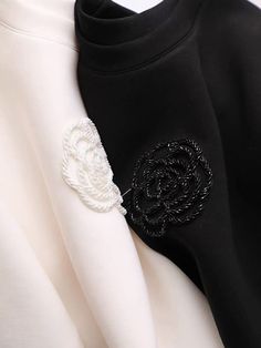 a black and white shirt with a flower on it