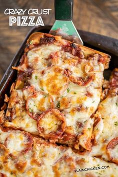 a pan filled with pizza sitting on top of a wooden table