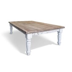 an old wooden table with white paint on the top and legs, against a white background