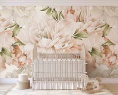 a baby crib in front of a floral wallpaper