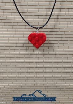 Custom handmade Heart Necklace made with genuine Lego® pieces. The necklace is made from waxed cotton cord and is 20” long and 1.5mm thick with a 2" extender chain and lobster clasp. These are made with all new parts including two standard Lego® heart shaped plates that have been glued together to provide long term durability. Vegas Brick Couple LLC is not affiliated with LEGO®. This product is fan art and the LEGO logo, are registered trademarks of The LEGO Group, which does not authorize, spon Valentine's Day Heart Pendant Necklace With Adjustable Cord, Red Adjustable Heart-shaped Necklace, Red Adjustable Heart Necklace, Adjustable Red Heart Necklace, Red Adjustable Heart Pendant Necklace, Adjustable Red Necklaces With Heart Charm, Adjustable Red Heart Necklace Gift, Adjustable Cord Heart Necklace, Red Heart-shaped Adjustable Necklace