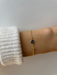 Brush away negative energy and jealous prying eyes with this dainty evil eye bracelet that you can customise by adding the gemstone/birthstone of your choice. D E T A I L S *It features a gold filled evil eye charm (12 x 6.5mm) in traditional blue *on an 18k gold filled chain in yellow gold.  *Gold fill or gold filled is an amazing quality alternative to solid gold. Unlike gold plating that over time tends to tarnish, gold filled is an actual layer of gold, pressure- bonded to another metal and Spiritual Round Evil Eye Bracelet, Handmade Elegant Evil Eye Bracelet Gift, Elegant Handmade Evil Eye Bracelet Gift, Minimalist Beaded Bracelet With Evil Eye For Gift, Dainty Evil Eye Bracelet With Adjustable Chain, Minimalist Evil Eye Beaded Bracelets As Gift, Handmade Elegant Evil Eye Bracelet For Everyday, Hypoallergenic Evil Eye Bracelet Gift, Spiritual Evil Eye Bracelet For Everyday