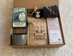 an open box with some items in it on a white carpeted floor next to a cup