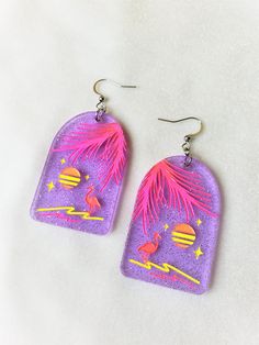 Retro Paradise-Fluorescent Flamingo Tropical EarringsApproximately 1.25" wide, and 2.75" long from top of metal hook.These tropical earrings are so rad! They are made with a violet super sparkly acrylic. The details are engraved and hand painted with fluorescent paint. The fluorescent paint glows under a blacklight (UV light). Please reference to pictures shown for blacklight and regular light to see the difference. These are really fun, bright tropical 80s themed earrings!This product is made t Handmade Neon Jewelry For The Beach, Handmade Neon Jewelry For Summer, Neon Jewelry For Summer Gifts, Summer Festival Purple Earrings With Ear Wire, Summer Purple Earrings With Ear Wire, Fluorescent Paint, Tropical Earrings, Flamingo Tropical, Neon Design