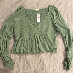 Sage / Light Green A Bay Doll Style Top Cute Long Sleeve Summer Tops, Cute Fitted Long Sleeve Tops, Cute Long Sleeve Tops For Spring, Cute Long Sleeve Spring Tops, Cute Long Sleeve Tops With Ruffles, Casual Long Sleeve Top With Ruffles For Spring, Cute V-neck Top For Fall, Cute Fitted Green Blouse, Cute Long Sleeve Relaxed Fit Tops