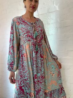 "This is beautiful light silky tunic dress with floral print in delicate blue and pink colours true boho chic style it is made loose and flared with high waist and long puff sleeve effortles to wear and easy fitting to all shapes perfect outfit for many occasions parties dinners birthday Christmas 😊 MEAESURE size M/L shoulders 18\" bust up to 40\" ( it is front tie srap, so can be easyli loosen up or tighten ) high waist 38\" length 45 \" MATERIAL *polisilk Thank You for looking" Spring Floral Print Dress With Balloon Sleeves, Chic Floral Print Dresses With Balloon Sleeves, Flowy Printed Dresses For Beach Cover-up, Spring Printed Beach Cover-up Dresses, Spring Oversized Dress With Balloon Sleeves, Spring Floral Print Billowy Dress, Bohemian Non-stretch Long Maxi Dress, Bohemian V-neck Tunic With Floral Print, Flowy Balloon Sleeve Spring Dress