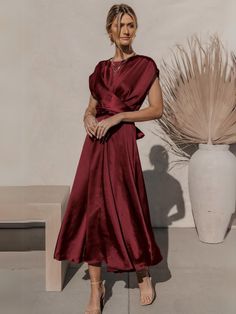 Burgundy Satin Holiday Dress, Chic Tea-length Bridesmaid Midi Dress, Chic Tea Length Bridesmaid Midi Dress, Satin A-line Midi Dress For Wedding Guest, Chic Satin Midi Dress For Wedding Guests, Chic Solid Color Bridesmaid Midi Dress, Spring Satin Midi Dress With Short Sleeves, Spring Short Sleeve Satin Midi Dress, Solid Color Satin A-line Evening Dress