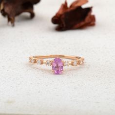 a pink ring sitting on top of a table