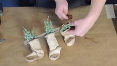 someone is making christmas stockings out of socking yarn and fake flowers on a table