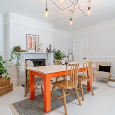 an orange table and chairs in a white room