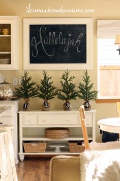 the kitchen is decorated for christmas with white cabinets and wood flooring, including a chalkboard