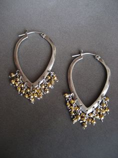 This item is made to order please allow 5 to 8 business days for your order to ship. This pair of earrings is the perfect alternative to a classic round hoop earring. The two tone combination of gold and silver, makes this pair very versatile and can easily be worn from day into evening. The hoops are solid sterling silver that have been lightly oxidized. Tiny faceted golden pyrite beads are individually hand wire wrapped, and dangle as a cluster from the hoop. They measure 1 3/4 inches in lengt Crescent Earrings, Casual Earrings, Baby Pearls, Mixed Metal Jewelry, Weird Shapes, Beaded Hoops, Pretty Earrings, Everyday Earrings, Circle Earrings