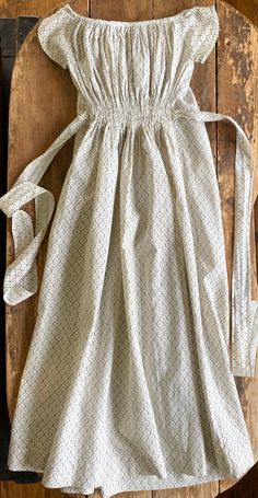 "Early cotton print baby gown. Wide neckline with tiny handmade rick rack trimmed cap sleeves. Ruched front waist with tie backs. Cotton print in browns on off-white ground. Completely hand stitched. Dates to 1870s and was worn by Effie Howell born 1872, later Dietrich. Very good condition with some light stains.  Measurements: 9\" across front at underarms length 29\"" Little Dorrit, Baby Girls Dresses, Cottagecore Outfits, Cotton Sundress, Rick Rack, Baby Gown, Feminine Outfit, Tie Backs, Maternity Clothes