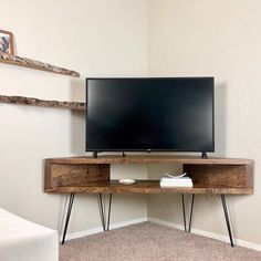 a flat screen tv sitting on top of a wooden stand