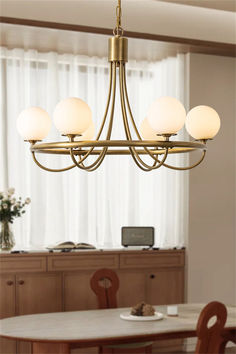 a chandelier hanging over a dining room table