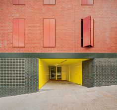 an empty parking garage in front of a brick building