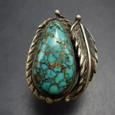 VINTAGE TURQUOISE with SPIDERWEB MATRIX STERLING SILVER RING DESCRIPTION: With a gorgeous cab of webbed matrix turquoise flanked by a sterling silver applied leaf, this ring will be a cherished addition to your collection of quality vintage Southwestern and Native American jewelry. MEASUREMENTS:  Ring face measures 1 1/8" x 7/8" RING SIZE: 7 1/2 WEIGHT:  9.5 grams SIGNED:  no STERLING:  unmarked, verified sterling silver Native American Words, Jewelry Measurements, Cowgirl Jewelry, Ring Pictures, Vintage Turquoise, American Jewelry, Native American Jewelry, Spider Web, Rings Statement