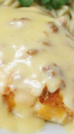 a close up of a plate of food with cheese and sauce on the top,