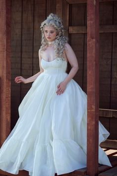 a woman in a white dress posing for a photo