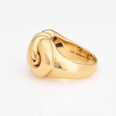 This is part of Chairish’s Fine Jewelry assortment.  Stylish Bulgari ring crafted in 18 karat yellow gold (circa early 2000s).    The design of the Doppio Cuore ring is inspired by the symbol of two intertwined hearts, representing love, connection and affection. Bulgari's designers drew inspiration from classical motifs while infusing a modern touch, characteristic of Bulgari's design aesthetic. The wide band is designed in an east to west position and is great worn alone as a statement piece or stacked. The ring weighs 18.8 grams and has a hefty feel on the hand. The low rise band (7mm - 0.27 inches) sits comfortably on the finger.     The ring is in very good condition and was lightly cleaned and polished.   Particulars:  Weight: 18.8 grams  Stones:    Size & Measurements: The ring is a Formal Modernist 14k Gold Ring, Modernist 14k Gold Ring For Formal Occasions, Modernist 14k Gold Hallmarked Rings, Modernist Yellow Gold Rings For Formal Occasions, Modernist Hallmarked Yellow Gold Jewelry, Hallmarked Modernist Yellow Gold Jewelry, Modernist Gold Wedding Rings, Modernist Gold Anniversary Rings, Modernist 14k Gold Formal Ring