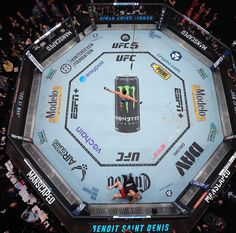 an overhead view of a wrestling ring with people watching