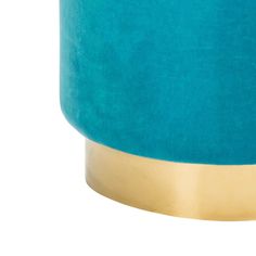 a teal and gold colored table lamp