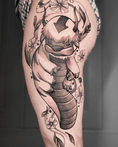 a woman's thigh with an animal tattoo on it