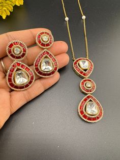 Premium Quality. This is a beautiful High gloss italian Mina Pendant set with uncut kundan and American Diamonds(CZ) with matching Dangle earrings is very sleek and modern. This set goes well with Indian as well as western outfit. This is so beautiful to look at and a perfect one for Indian weddings.  Color : gold, Red Necklace length : 22 inch Pendant width : 1 inch Earring length : 1.8 inch Earring width : 1 inch Each Earring Weight: 10.4 Grams Material : Uncut Kundan, moissanite kundan, CZ, I Traditional Jewelry With Sparkling Stones For Gift, Diamond Kundan Necklace Gift, Diamond Kundan Pendant Necklace For Gift, Hand Set Round Kundan Necklace Gift, Hand-set Round Kundan Necklace Gift, Dazzling Hand Set Jewelry Sets For Gift, Dazzling Hand Set Jewelry Sets As Gifts, Traditional Cubic Zirconia Jewelry Sets Gift, Dazzling Hand-set Jewelry Sets For Gifts