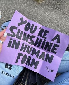 someone holding up a sign that says you're sunshine in human form