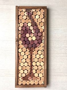 a wine glass made out of corks in a wooden box