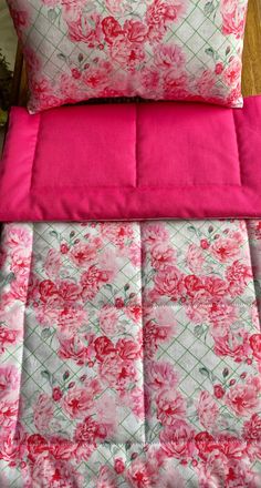 pink and white floral bedding with matching pillows