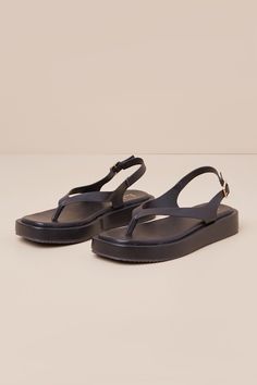 From the beach bar to late night ice cream dates, the Lulus Maralynn Black Flatform Thong Slingback Sandals will always get you there looking casually cute! These trendy sandals have a faux leather construction that shapes a square footbed and thong-style upper that flows into an adjustable slingback strap with a gold buckle. A perfectly chunky flatform sole completes the summery look! Available in whole sizes only. 1. 25" flatform rubber sole. Lightly cushioned insole. Rubber sole has nonskid m Strappy Synthetic Slingback Sandals For Beach, Synthetic T-strap Sandals For Beach, Summer T-strap Sandals For Beach, Summer Beach T-strap Sandals, Summer T-strap Synthetic Sandals For Vacation, Trendy T-strap Sandals For Beach Vacation, Trendy T-strap Sandals For Beach Season Vacation, Summer Jelly Sandals With Adjustable Strap, Summer Synthetic Jelly Sandals With Adjustable Strap